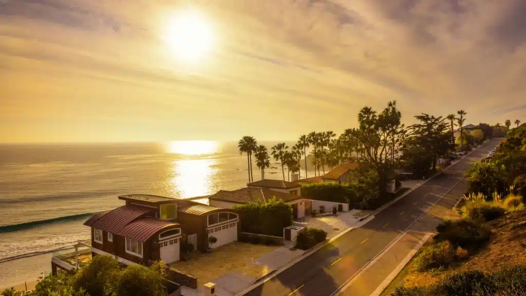 Malibu coastline homes at sunset with palm trees
